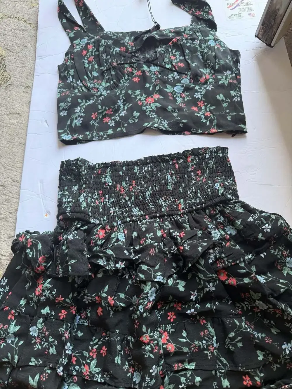 Olivaceous Black Floral Two-Piece Set with Smocked Ruffle Skirt and Crop Top
